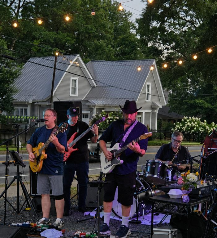 Big Creek Country Band performing outdoors under string lights in Roswell
